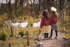 twee meisjes staan kijkend voor een groenteveld